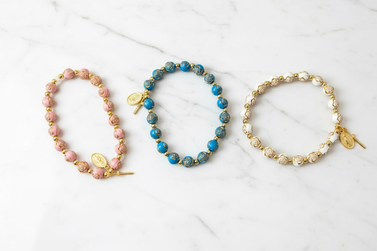Bracelet: pink St. Therese ; teal OL of Guadalupe ; ivory Mary Queen of Heavengold rosary bracelet